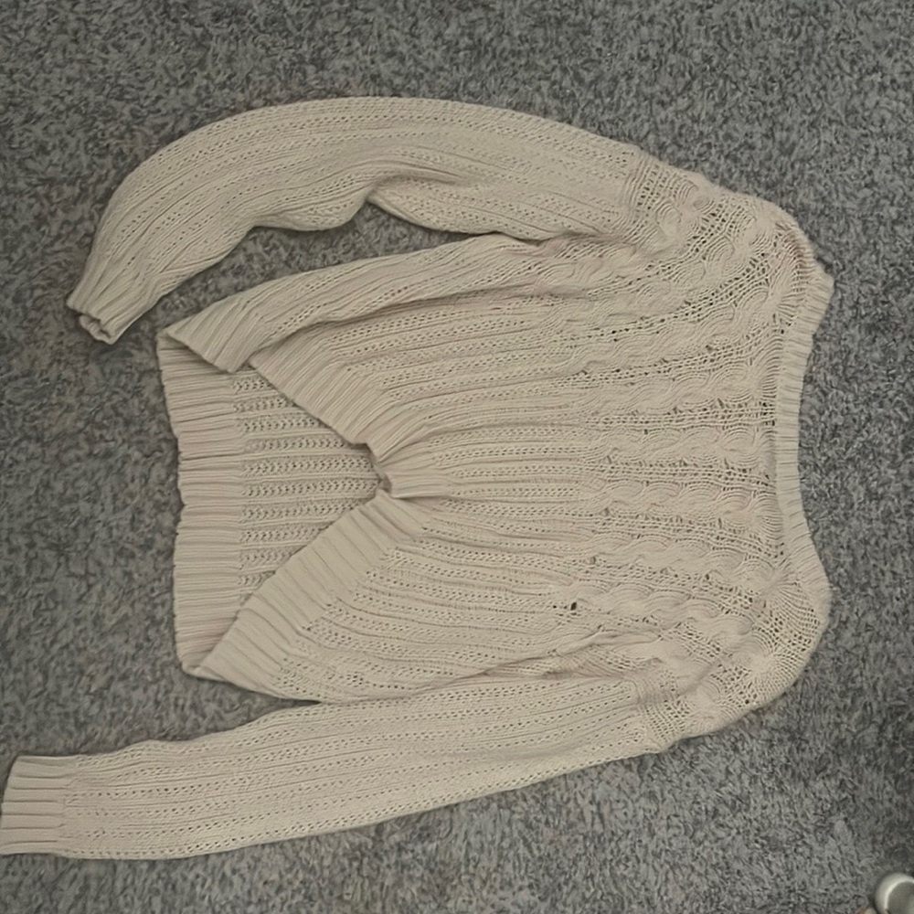 cream sweater cropped in the fron